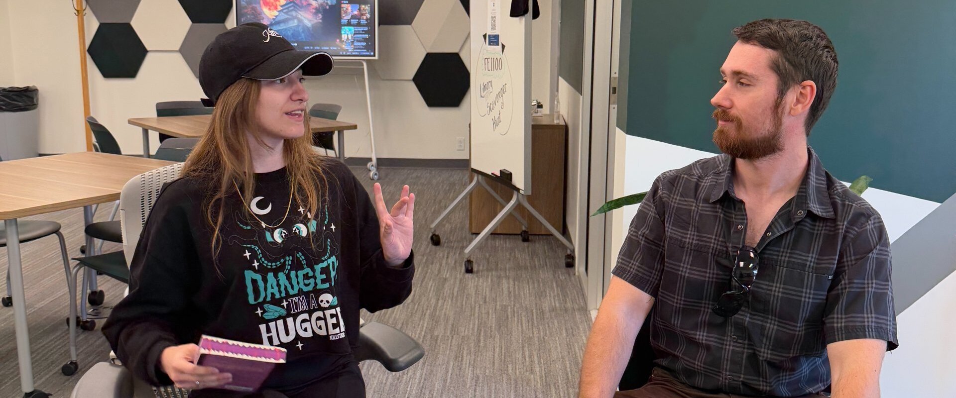 ETC major Mia Jaegers working in writing lab helping a student